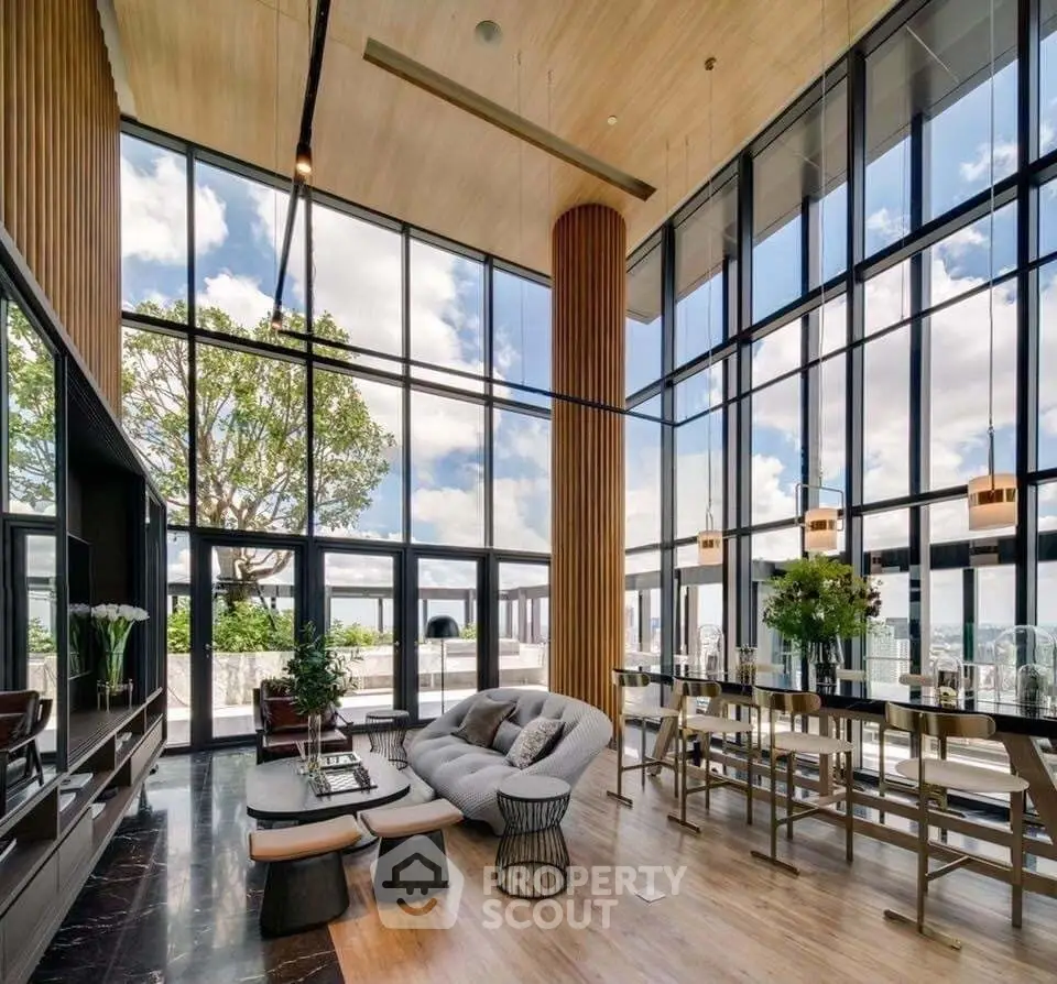 Luxurious modern living room with floor-to-ceiling windows and stunning city view.