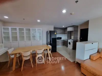 Modern open-plan living area with kitchen, dining table, and cozy seating.