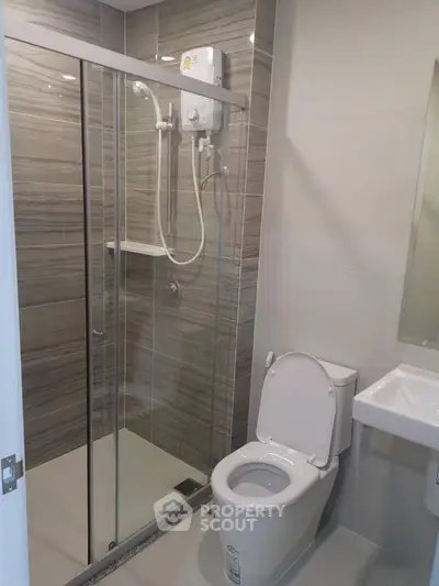 Modern bathroom with glass shower enclosure and sleek fixtures