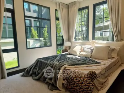 Luxurious bedroom with large windows and elegant decor in modern home