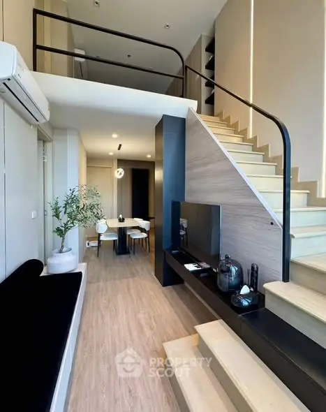 Modern duplex living room with stylish staircase and open layout