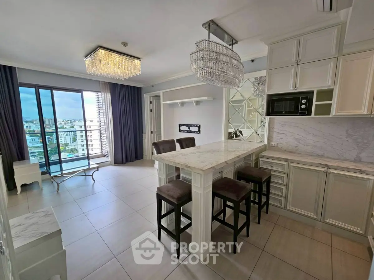 Luxurious open-layout kitchen with elegant island and stunning city view