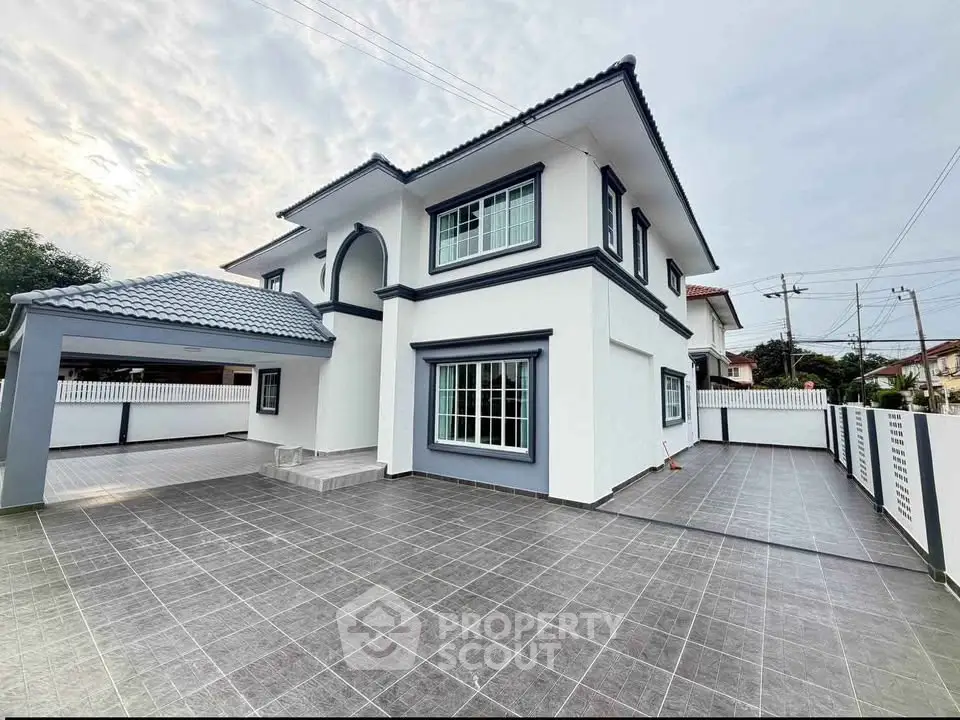 Stunning modern two-story house with spacious driveway and elegant exterior design.