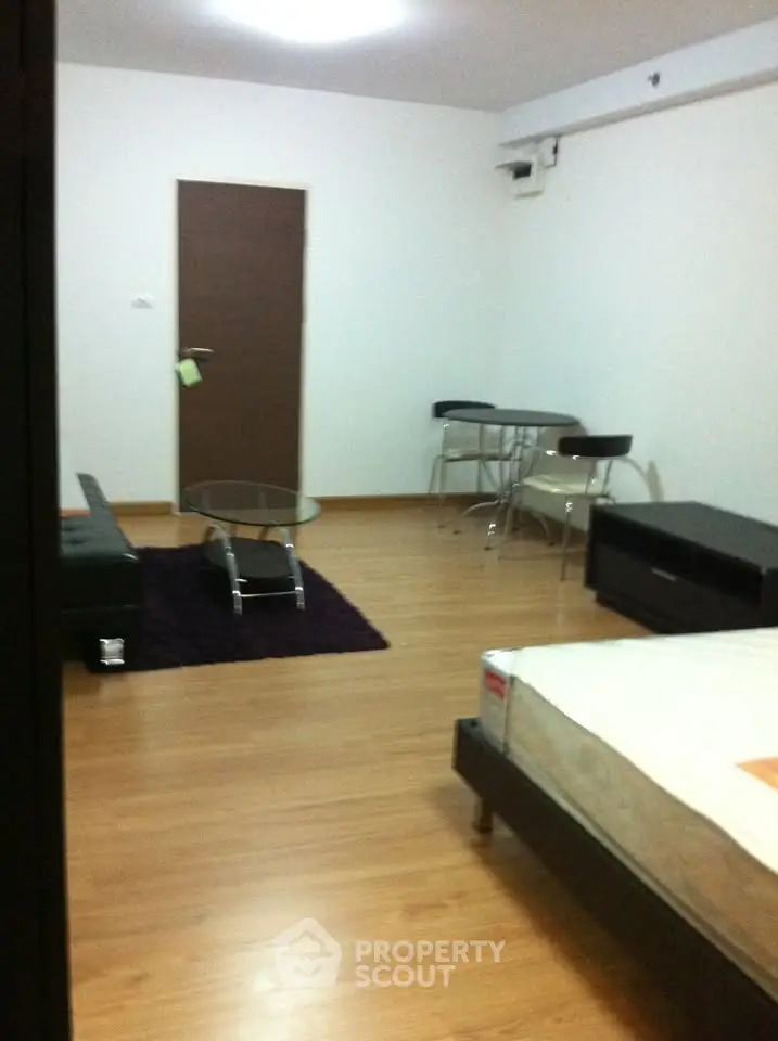 Modern studio apartment with wooden flooring and minimalist furniture