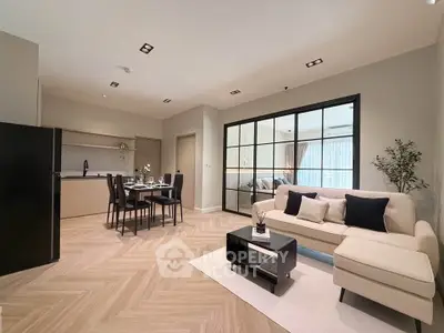 Modern open-plan living room with elegant dining area and stylish kitchen