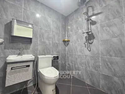 Modern bathroom with sleek gray tiles and contemporary fixtures