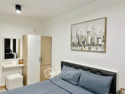 Modern bedroom with stylish decor and comfortable bedding in a contemporary apartment.