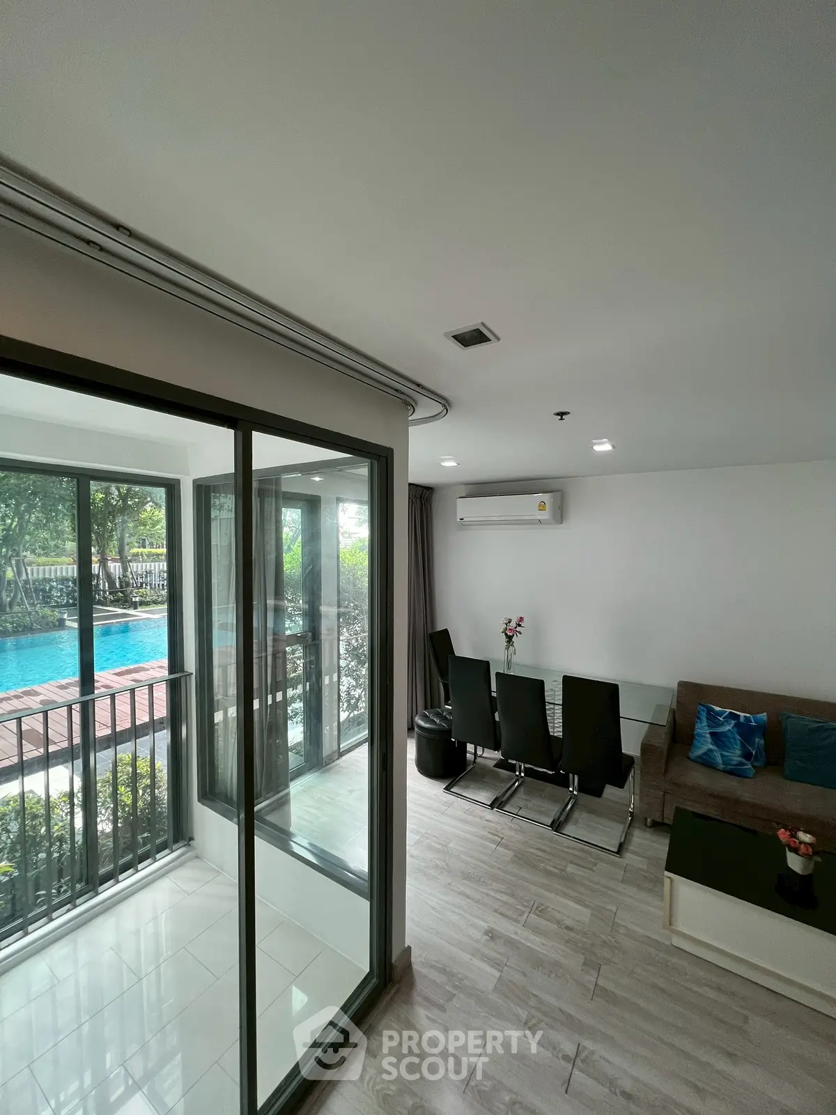 Modern living room with pool view and sleek interior design