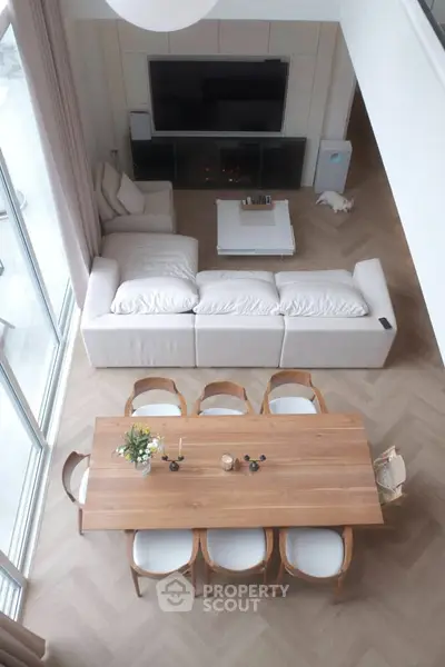 Spacious modern living room with elegant dining area and cozy seating.