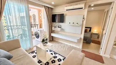 Modern living room with balcony access and cozy bedroom view