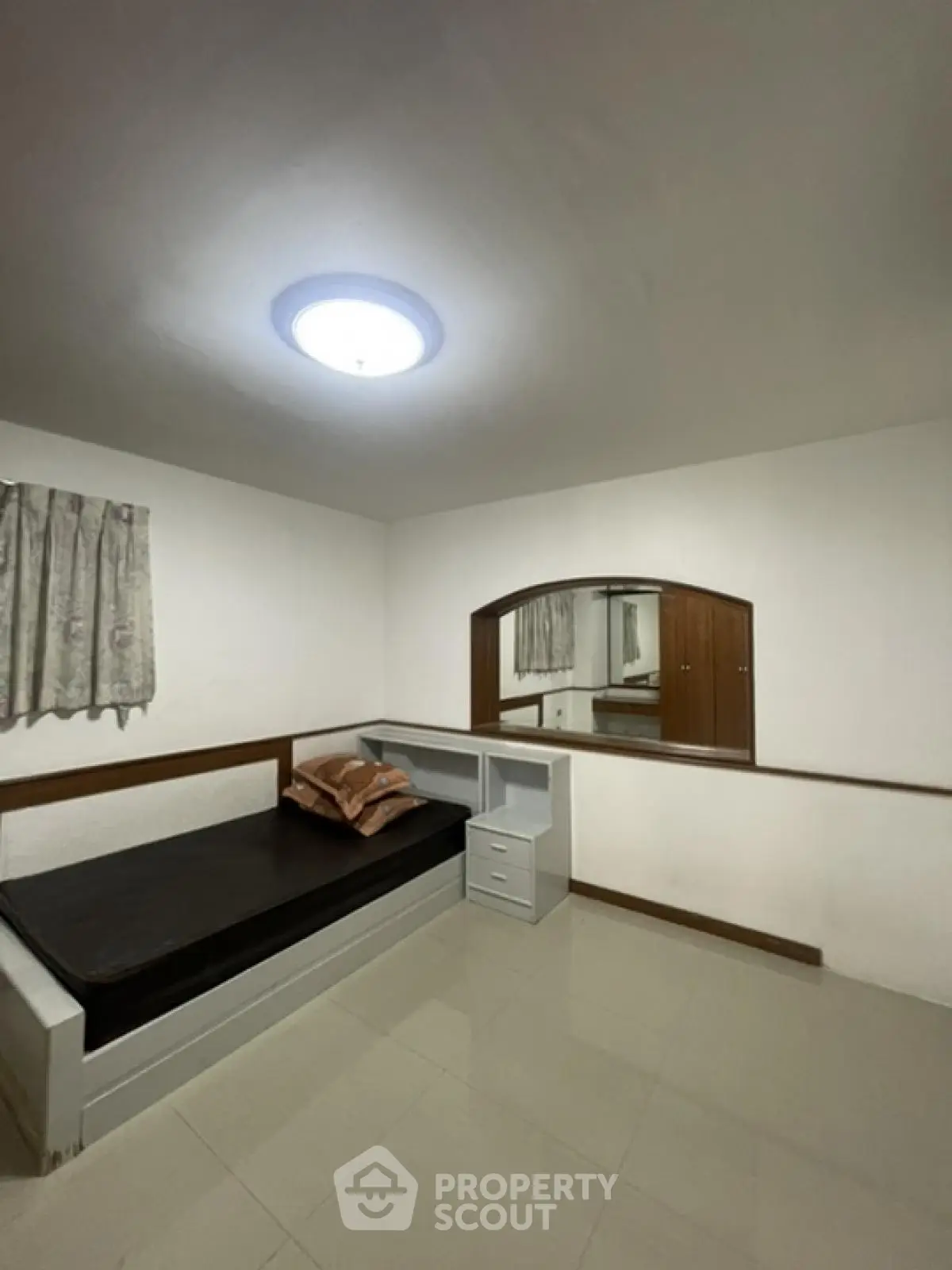 Minimalist bedroom with single bed and built-in storage