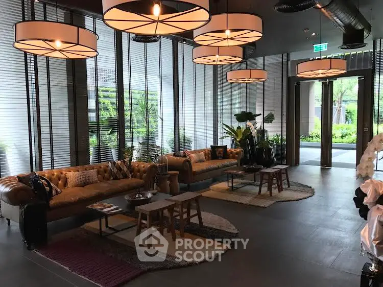 Luxurious modern lobby with stylish seating and large windows overlooking greenery.
