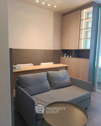 Modern living room with cozy sofa and stylish wooden cabinetry