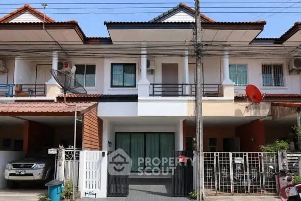 Charming townhouse exterior with modern design and gated entrance in a suburban neighborhood.