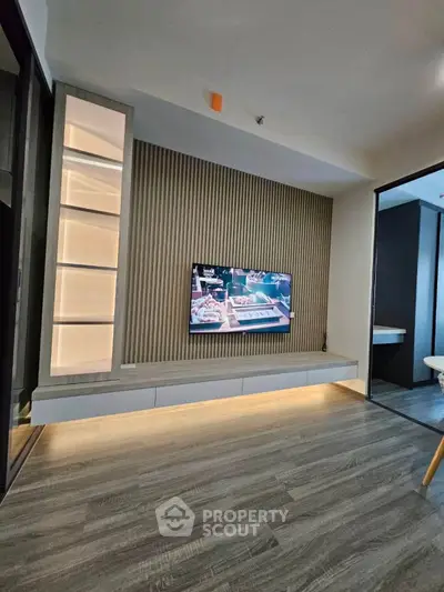 Modern living room with sleek TV setup and ambient lighting