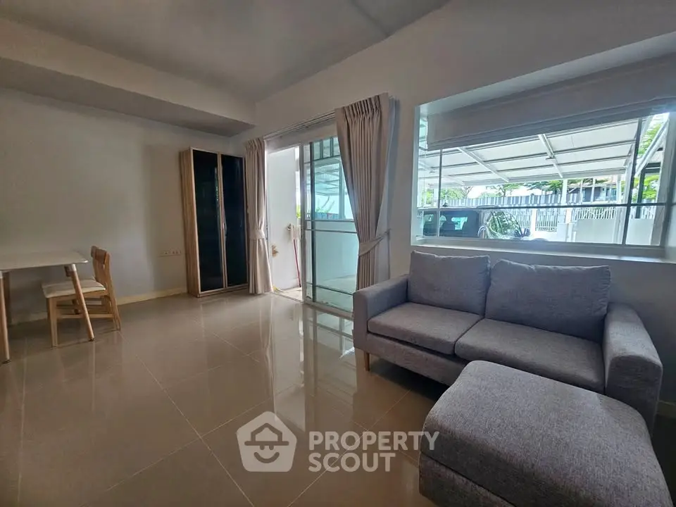 Spacious living room with modern furniture and large windows for natural light.
