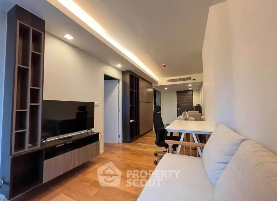 Modern living room with wooden flooring and sleek furniture design