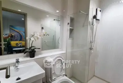 Modern bathroom with glass shower and sleek fixtures in a stylish apartment.