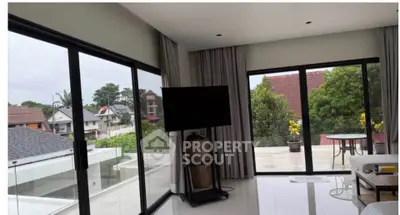 Spacious living room with large windows and balcony offering stunning views