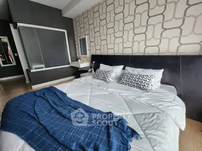 Stylish bedroom with modern decor and cozy bedding in a contemporary apartment.