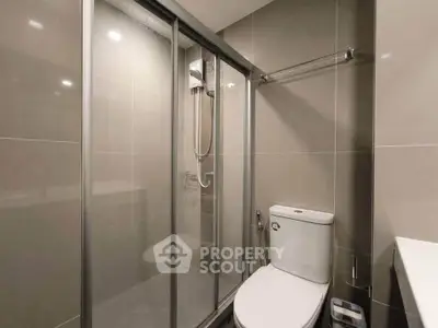 Modern bathroom with sleek shower enclosure and contemporary fixtures.