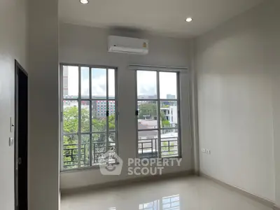 Bright and airy apartment with large windows and city views, perfect for modern living.