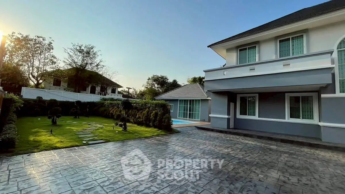 Stunning two-story home with spacious driveway and lush garden, perfect for family living.