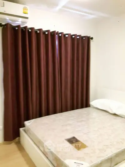Cozy bedroom with air conditioning and elegant curtains in modern apartment.