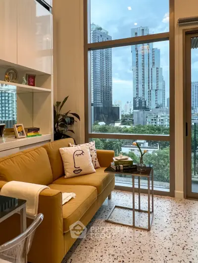 Modern living room with large windows and city view, featuring stylish yellow sofa and chic decor.