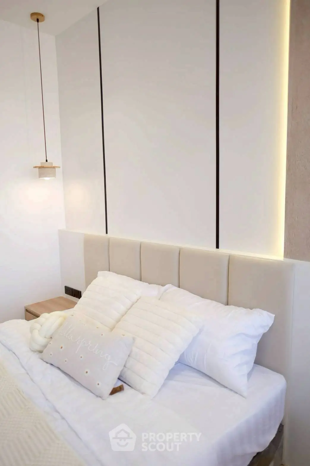 Elegant bedroom with modern lighting and cozy bedding