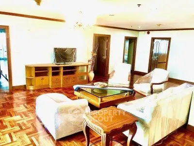 Spacious living room with elegant wooden flooring and stylish furniture