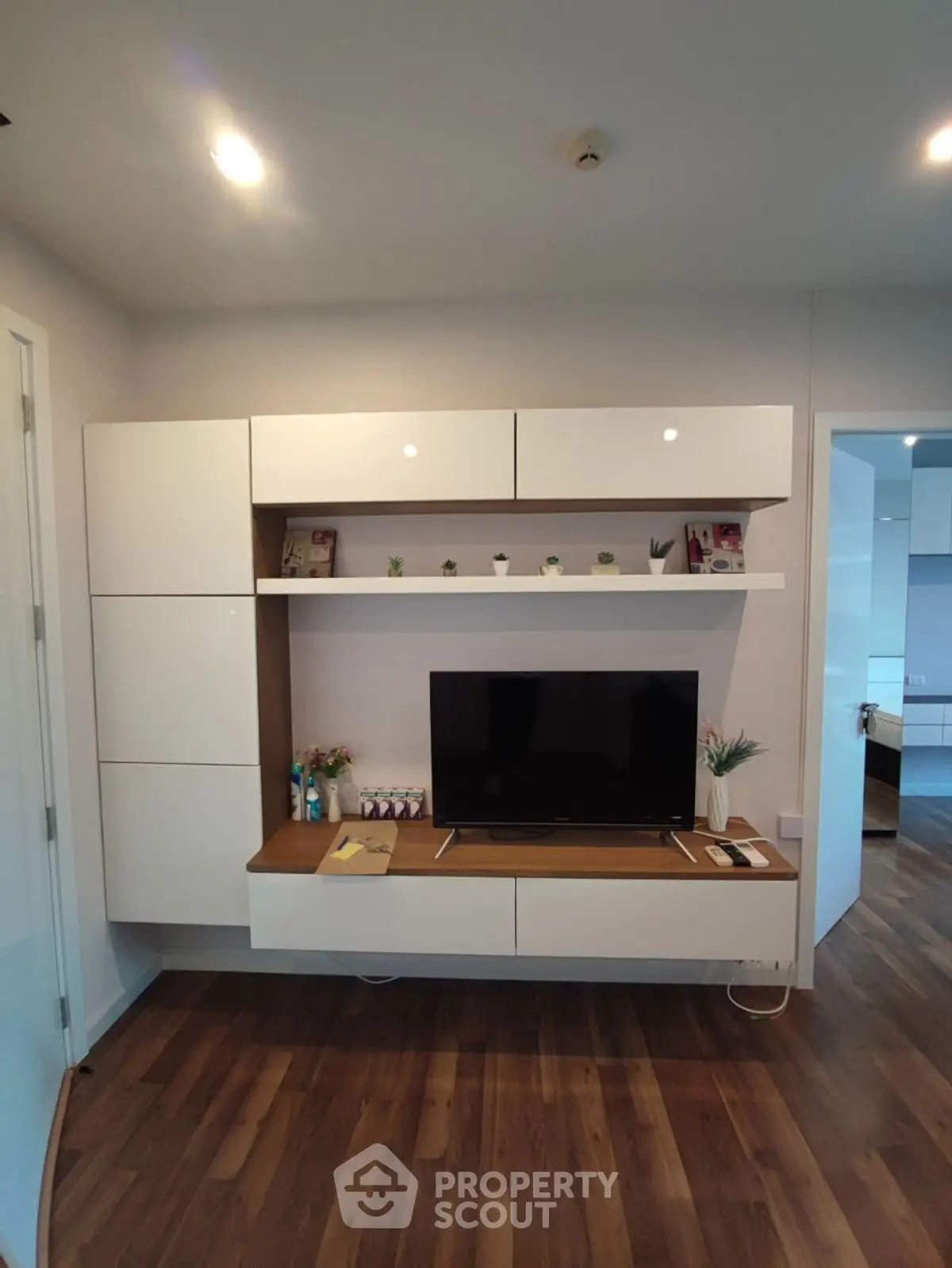 Modern living room with sleek TV unit and wooden flooring