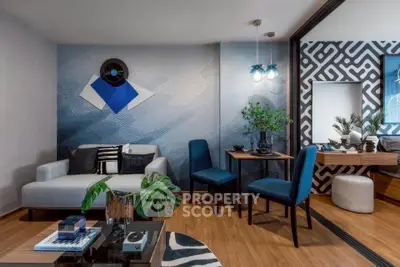 Stylish modern living room with blue accents and geometric wall design