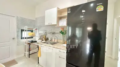Modern kitchen with sleek black fridge and stylish backsplash