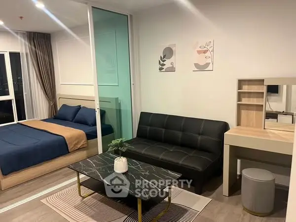 Modern studio apartment with stylish living area and cozy bedroom