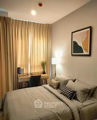 Cozy bedroom with modern decor, featuring a stylish bed, desk, and elegant artwork, perfect for relaxation.