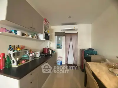 Cozy kitchen with modern appliances and ample storage space, perfect for culinary enthusiasts.