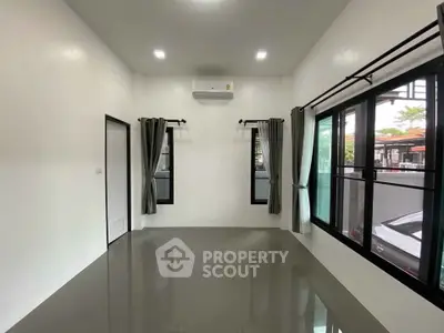 Spacious modern room with large windows and sleek flooring