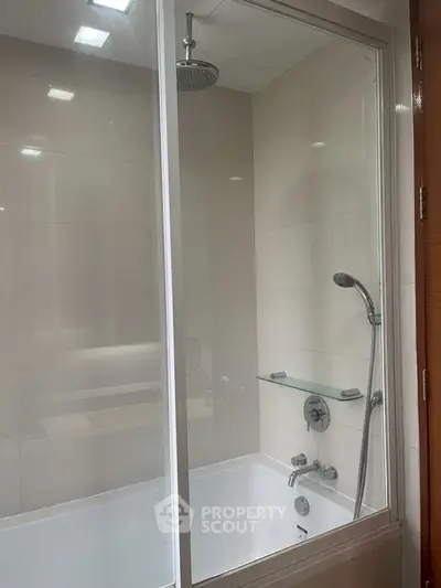 Modern bathroom with glass shower enclosure and sleek fixtures
