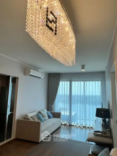 Stylish living room with elegant chandelier and stunning city view