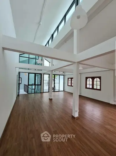 Spacious modern living room with high ceilings and large windows