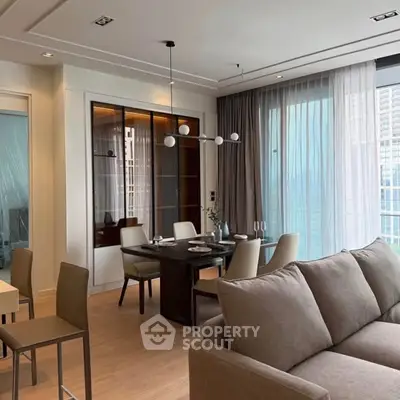 Modern living room with elegant dining area and large windows offering city views.