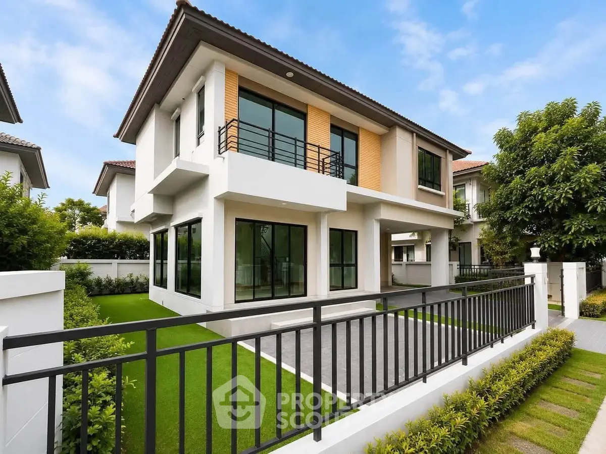 Modern two-story house with large windows and landscaped garden in a serene neighborhood.
