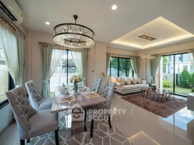 Luxurious open-plan living room with elegant dining area and modern decor.