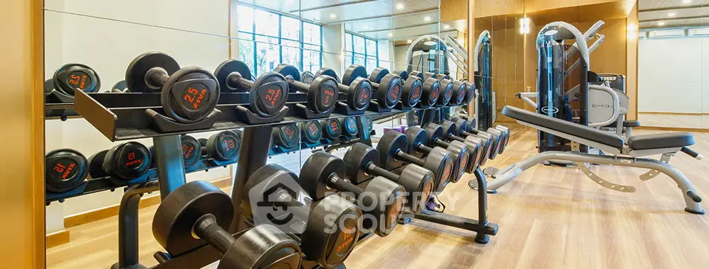 Modern gym with state-of-the-art equipment and ample natural light.