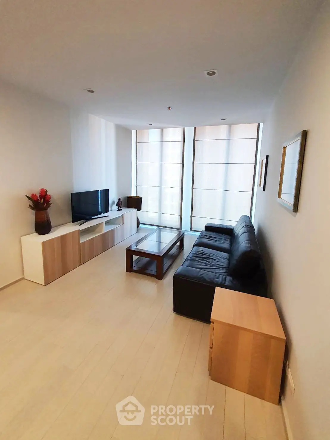 Modern living room with sleek furniture and large windows, perfect for relaxation and entertainment.