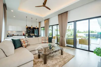 Luxurious open-plan living room with pool view and modern decor