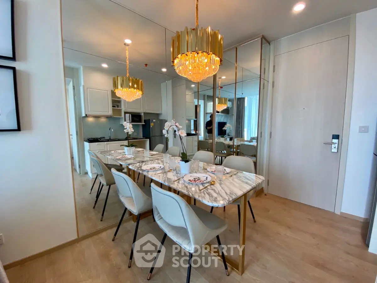 Luxurious dining area with elegant chandelier and marble table in modern apartment