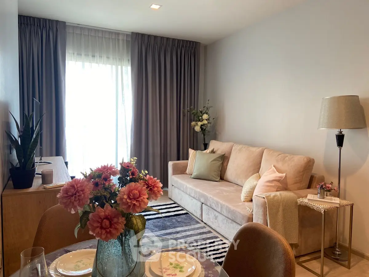 Charming living room with cozy sofa, elegant decor, and abundant natural light for a welcoming ambiance.