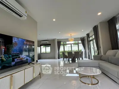 Spacious modern living room with elegant decor and large windows for natural light.